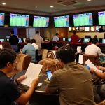 Placing bets during a lively sports event, creating tin soi kèo strategies in an upscale sportsbook.